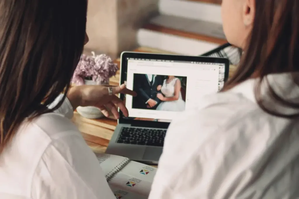 Wedding photographer showing package options on a laptop”