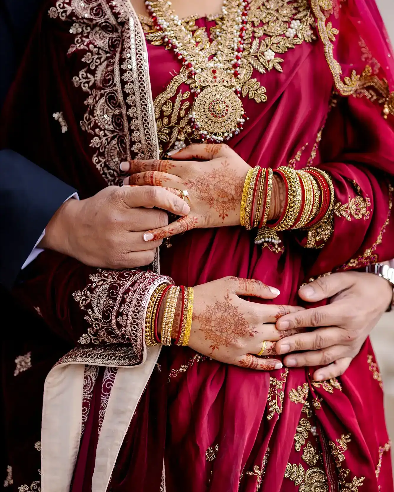 Intimate close-up of bride and groom holding hands during their wedding ceremony