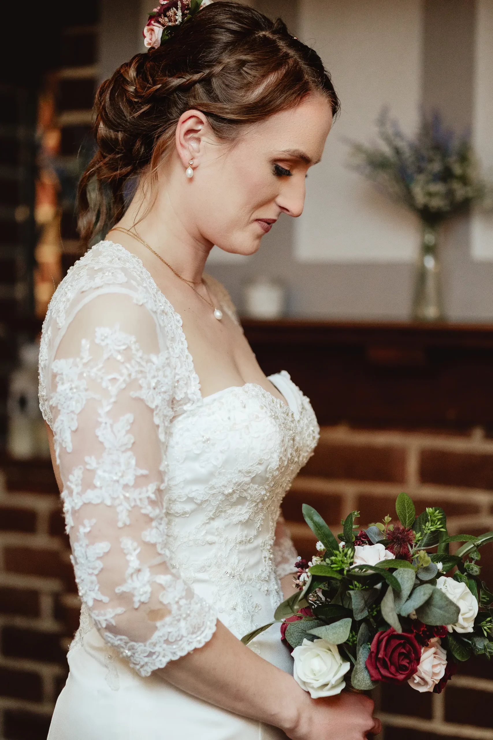 Editorial bridal portrait with lace sleeves in a moody indoor corner at Ampfield Golf Club