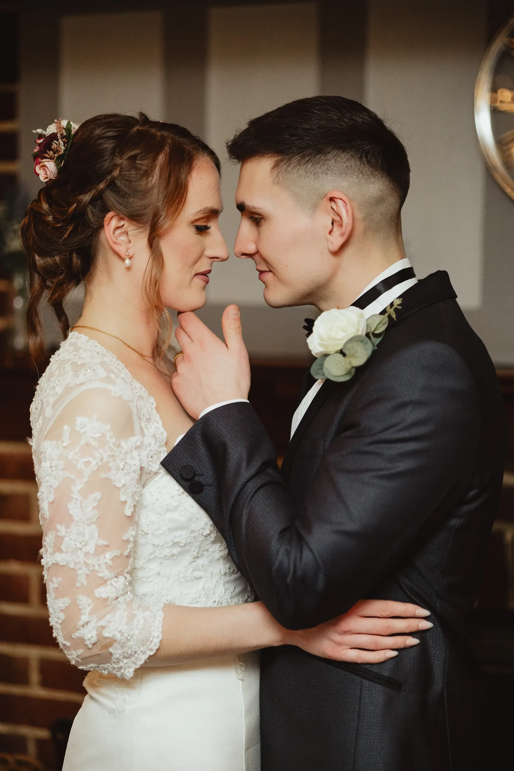 Editorial bridal portrait with lace sleeves in a moody indoor corner at Ampfield Golf Club