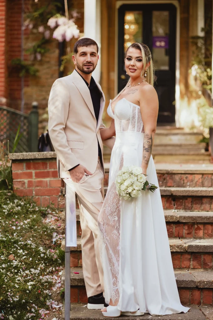 Bride in white dress portrait at Guildford Registry Office stairs, elegant wedding photography Surrey
