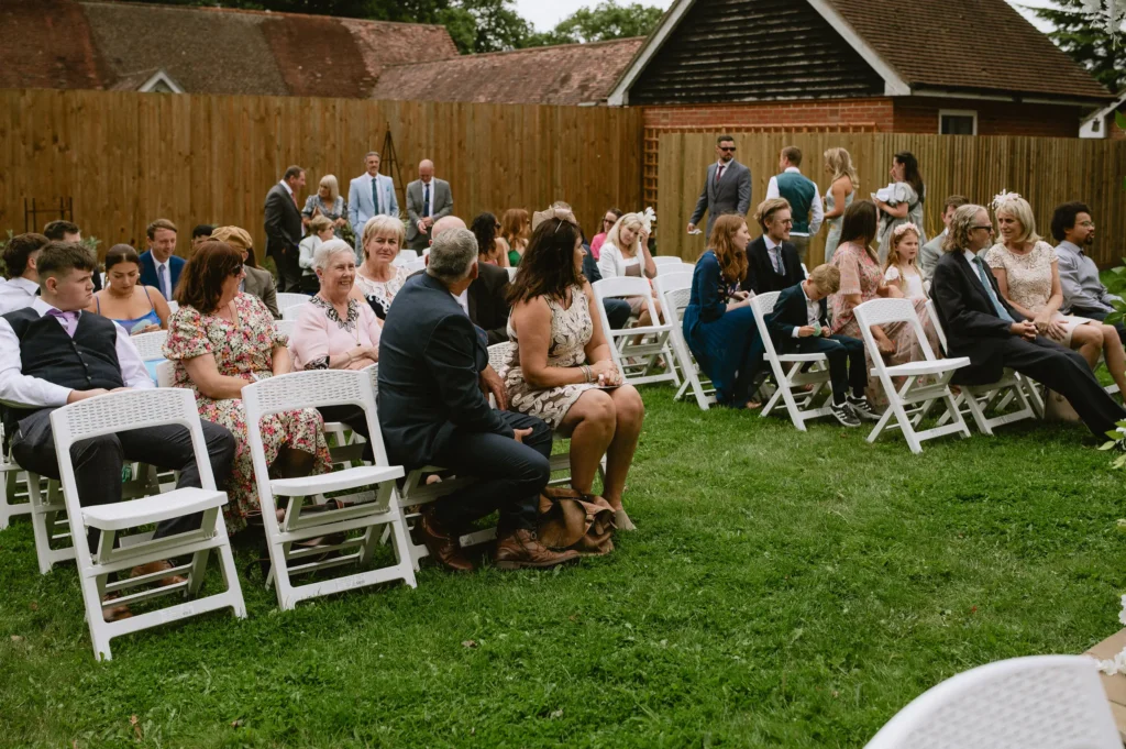 guest waiting at the outdoor ceremony setup at The Angel Hotel, Alton, Hampshire — candid wedding photography by VasPhotography