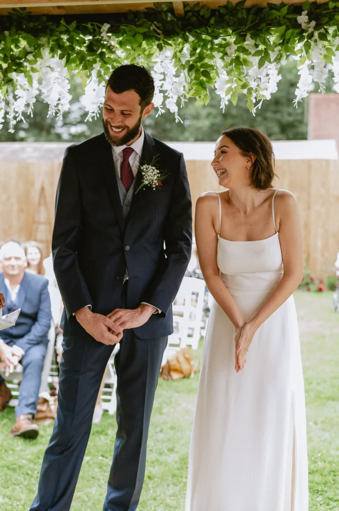 bride and groom having a giggle at The Angel Hotel, Alton, Hampshire — candid wedding photography by VasPhotography