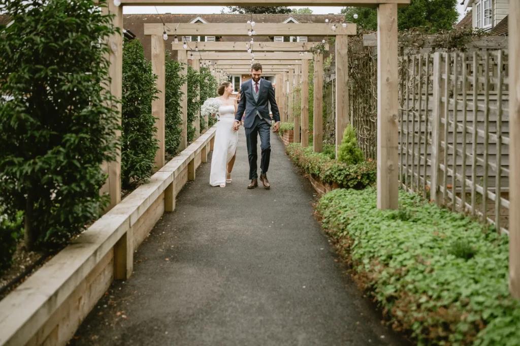 couple walking at The Angel Hotel, Alton, Hampshire — candid wedding photography by VasPhotography