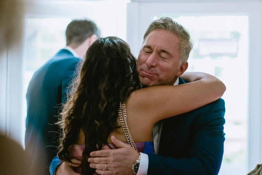 two people hug at The Angel Hotel, Alton, Hampshire — candid wedding photography by VasPhotography