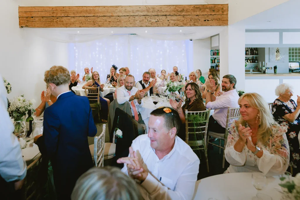 Wedding guests laughing during speeches at The Angel Hotel, Alton, Hampshire