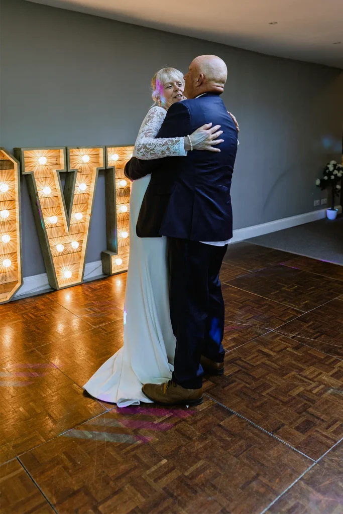 Sarah & Martin's first dance under light-up letters at The Angel Hotel, Alton — wedding photography by VasPhotography