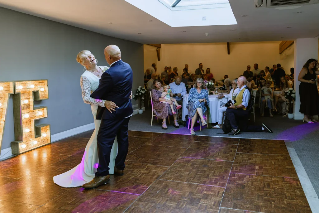 Sarah & Martin's first dance under light-up letters at The Angel Hotel, Alton — wedding photography by VasPhotography
