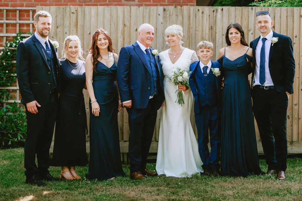 Wedding party group portrait in the gardens at The Angel Hotel, Alton, Hampshire