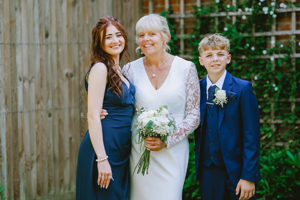 Wedding party group portrait in the gardens at The Angel Hotel, Alton, Hampshire